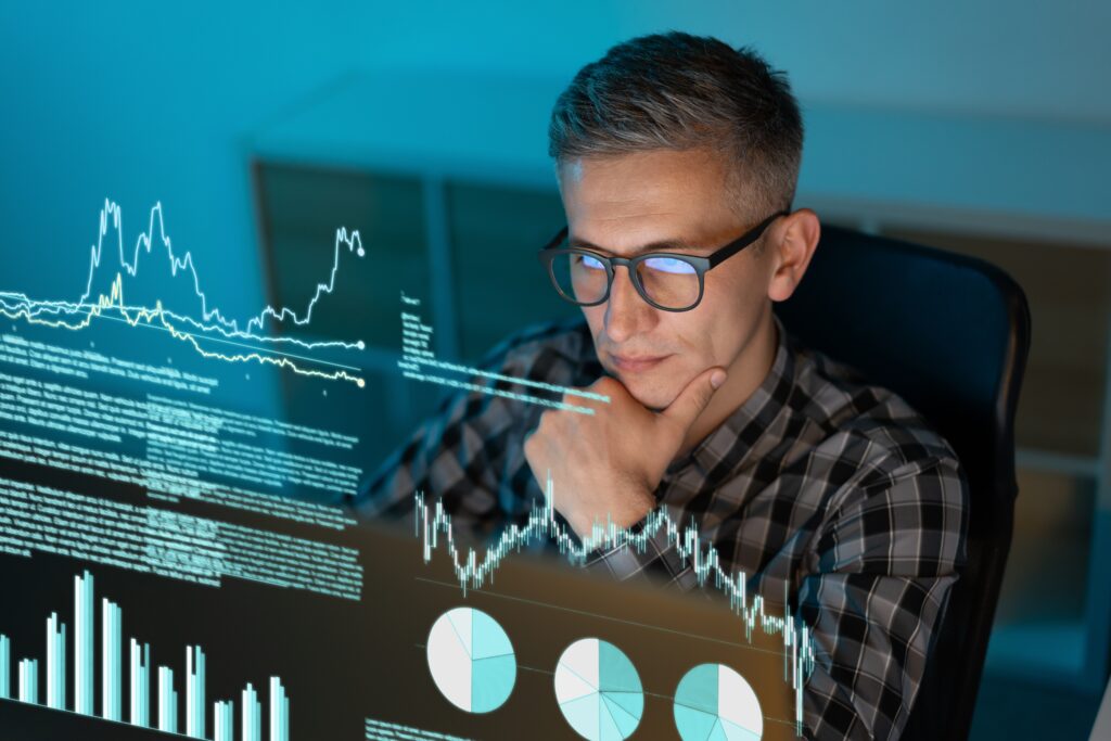 Focused,Analyst,Examining,Data,Visualizations,And,Charts,On,Screen