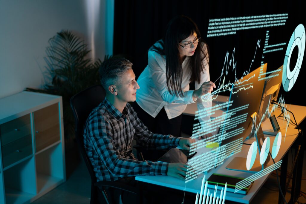 Team,Of,Professionals,Analyzing,Data,On,Multiple,Computer,Screens,,Highlighting