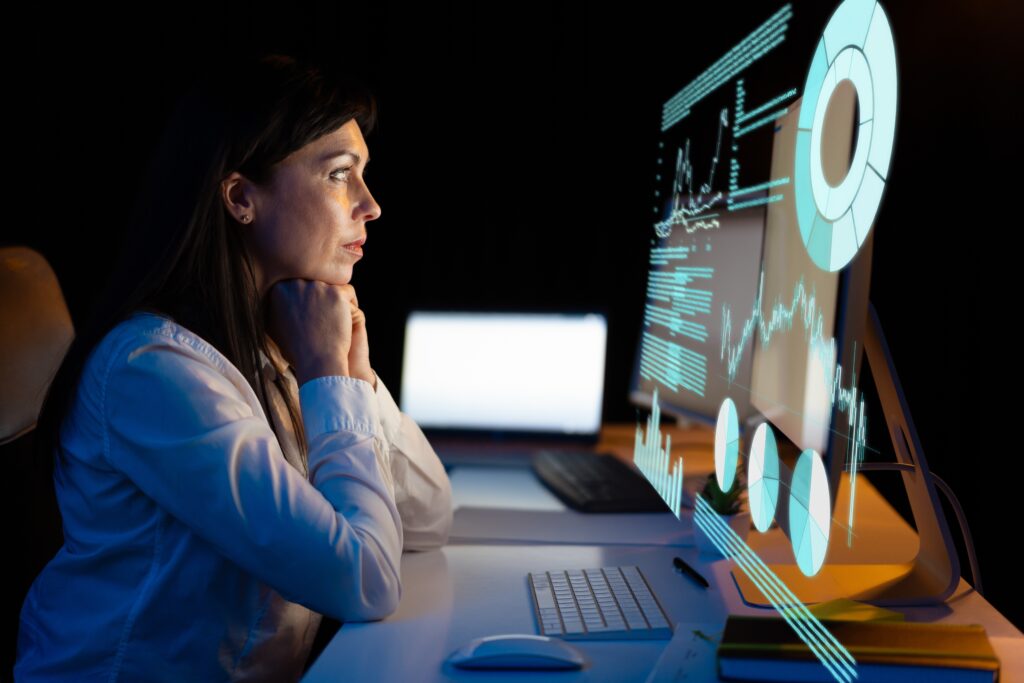 Woman,Analyzing,Data,On,Computer,Screen,,Reflecting,On,Analytics,,Innovation,